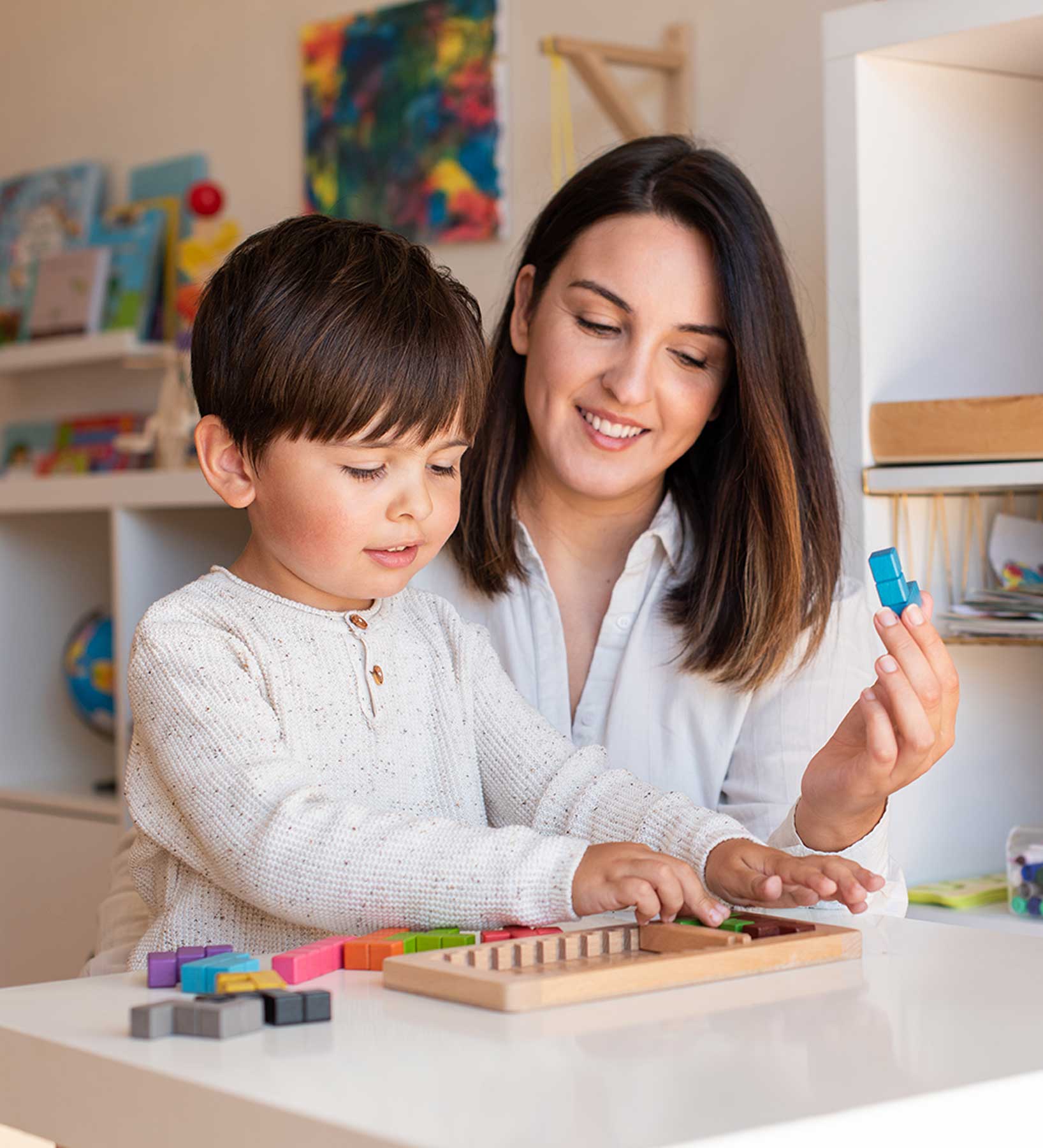 kid-playing-with-a-tetris-wood-puzzle-and-mother-o-2021-09-02-10-31-17-utc